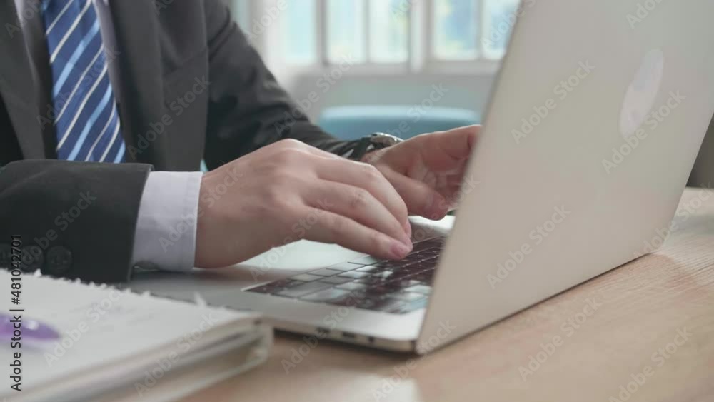 Close Up Of Asian Businessman Wearing Business Suit Typing On Computer While Working At Home.
Close Up Of Asian Businessman Wearing Business Suit Typing On Computer While Working At Home.