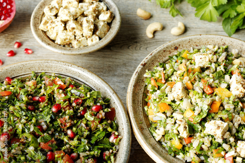 Traditional Tabbouleh salad with parsley and other tabbouleh style salad with barley and feta. Middle Eastern cuisine. photo