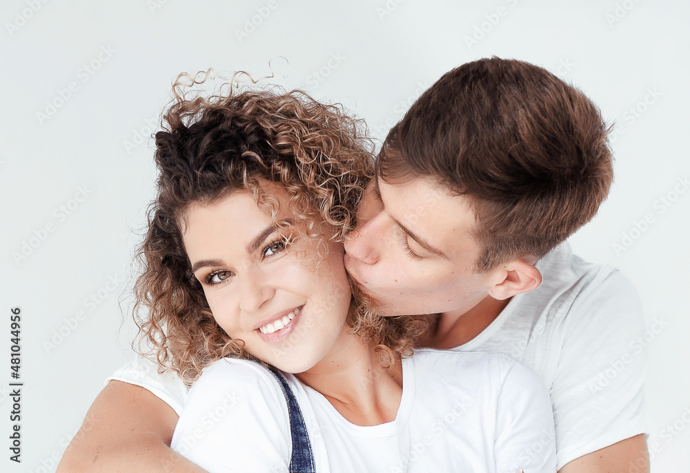 Portrait of a hugging couple on light background, st. Valentine's Day concept Portrait of a hugging couple on light background, st. Valentine's Day concept