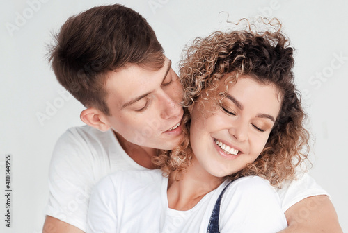 Portrait of a hugging couple on light background, st. Valentine's Day concept