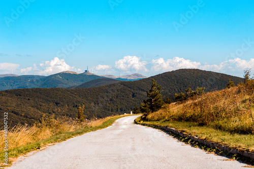 Road at a Balkan Mountains, Bulgaria with a view to Buzludzha monument photo