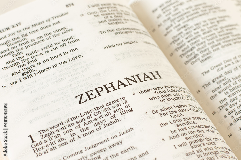 Zephaniah open Holy Bible Book close-up. Old Testament Scripture prophecy. Studying the Word of God Jesus Christ. Christian biblical concept of faith, trust, and hope. Zephaniah open Holy Bible Book close-up. Old Testament Scripture prophecy. Studying the Word of God Jesus Christ. Christian biblical concept of faith, trust, and hope.
