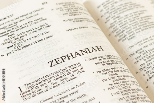 Zephaniah open Holy Bible Book close-up. Old Testament Scripture prophecy. Studying the Word of God Jesus Christ. Christian biblical concept of faith, trust, and hope. photo