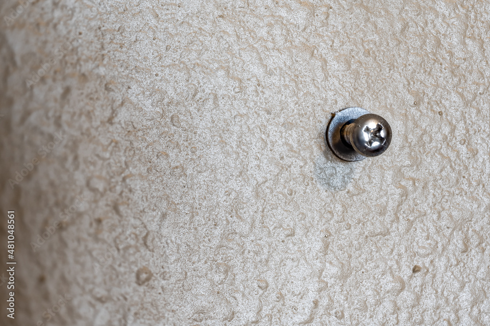 Selective focus on a typical drywall anchor installation . Selective focus on a typical drywall anchor installation .