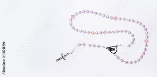 Holy catholic rosary and a cross - Text space photo