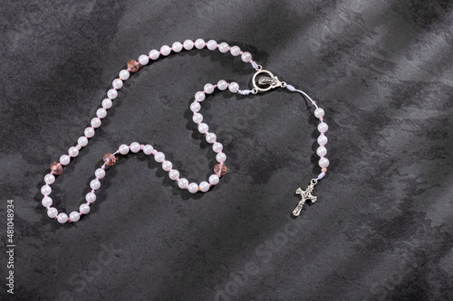 Holy catholic rosary and a cross - Text space