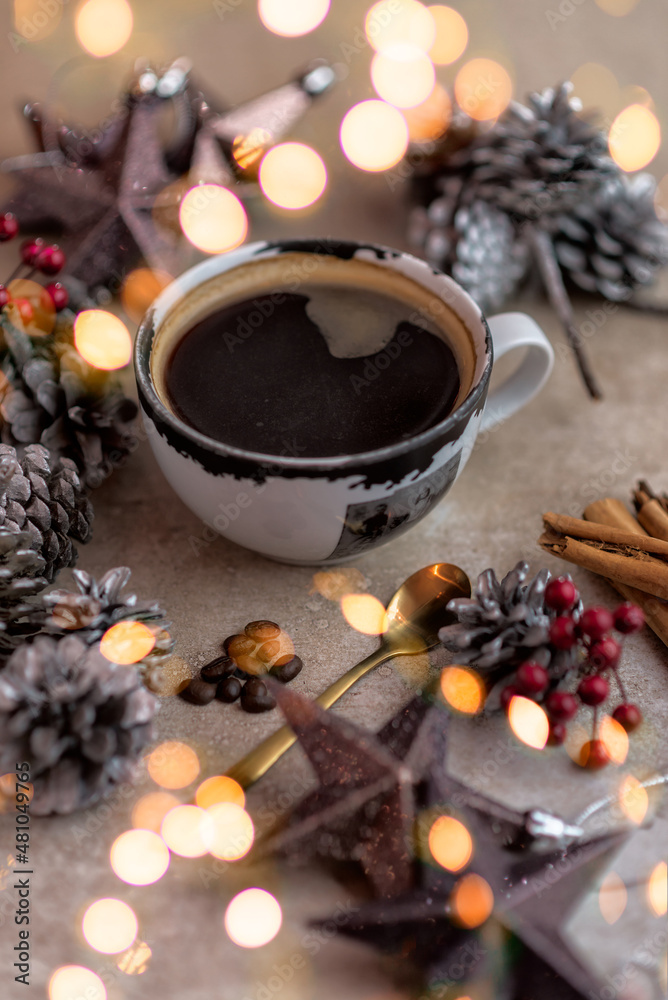 Black coffee mug decorated with pine cones berries and cinnamon sticks Black coffee mug decorated with pine cones berries and cinnamon sticks
