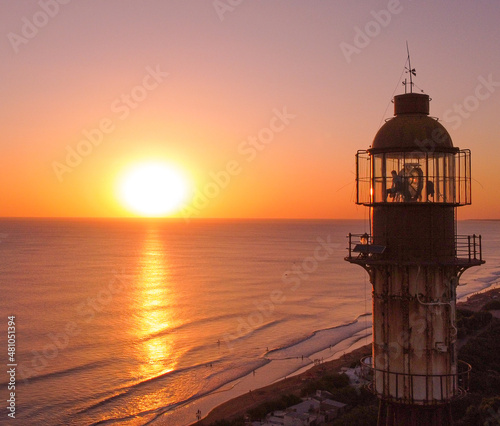 Aerial Picture Around A Light House With Beautiful Sunset Over Ocean