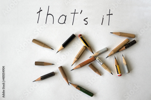 Ironic retirement farewell note 'that's it' with worn pencils on white background