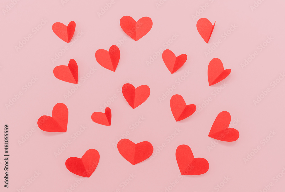 Flat lay photo for Valentine's Day background. Many red paper hearts on pink background