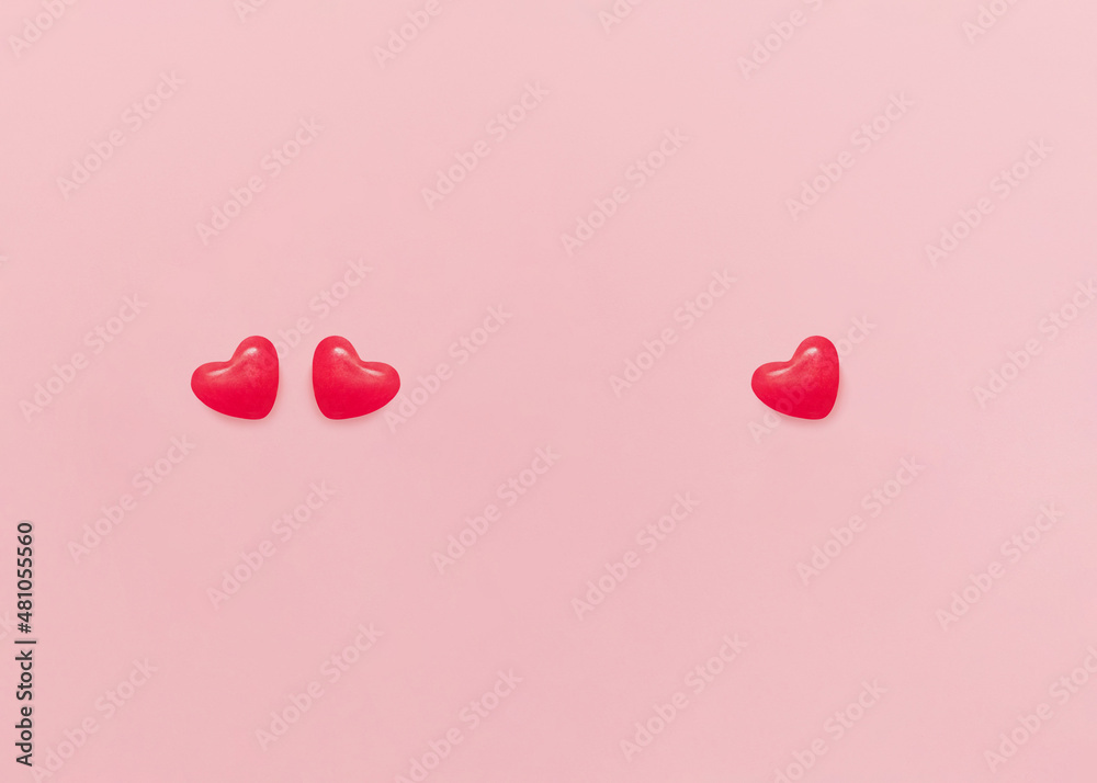 Valentine's day concept. Top view photo with copy space. Candies in heart shapes on pink background