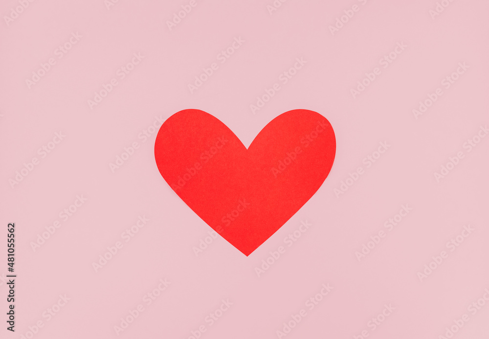 Valentine's Day sign. Top view photo in minimal style. Big red paper heart on pastel pink background