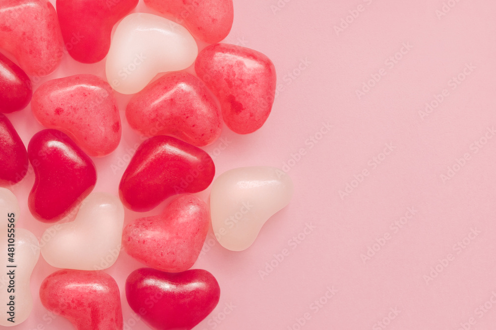 Love symbols. CLose up photo with copy space. Colorful jelly candies on pink pastel background Love symbols. CLose up photo with copy space. Colorful jelly candies on pink pastel background