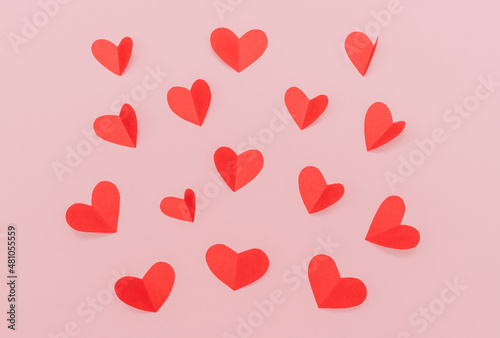 Flat lay photo for Valentine's Day background. Many red paper hearts on pink background
