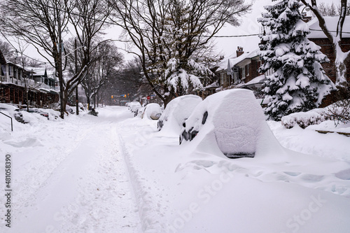  As a blizzard sweeps into a residential neighbourhood the streets fill with snow and residents start to shovel out their cars and sidewalks. Shot in the Toronto   s Beaches  in January. Room for text.