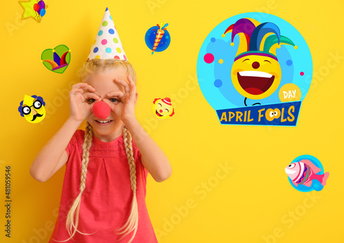 Funny little girl with clown nose and party hat on color background. April Fool s Day celebration