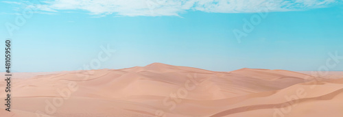 Scenic view of sand dunes on a bright sunny day with blue skies and orange sand