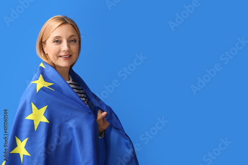 Mature woman with flag of E...