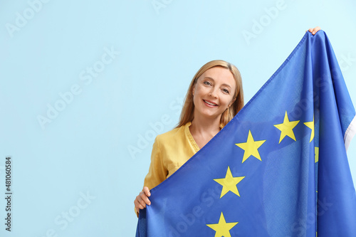 Mature woman with flag of European Union on color background