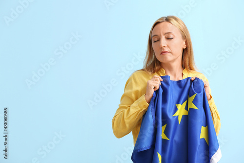 Mature woman with flag of E...