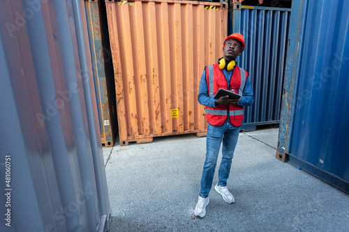 Wallpaper Mural Male African American person foreman using tablet checking list containers loading. Industrial logistics import export and shipping. Torontodigital.ca
