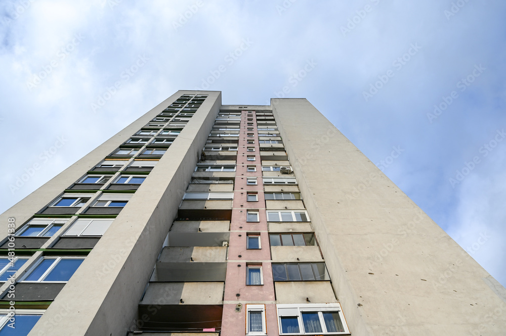 Old facade on tall building in town. Apartment windows and balconies in residential building. Exterior of apartment building in the city. Architecture. Real estate. Old facade on tall building in town. Apartment windows and balconies in residential building. Exterior of apartment building in the city. Architecture. Real estate.