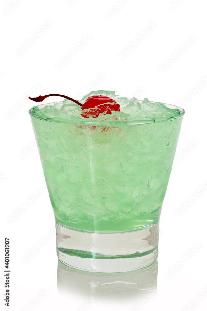 Green alcoholic shot glass with absent, ice and cherry Green alcoholic shot glass with absent, ice and cherry