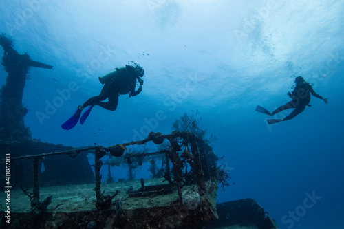 divers enjoying a deep wreck ship
