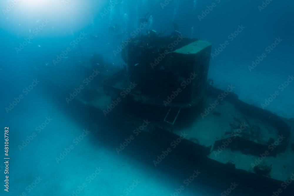 Fototapeta premium divers enjoying a deep wreck ship