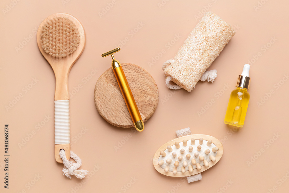 Face massage roller with bathing supplies on color background Face massage roller with bathing supplies on color background