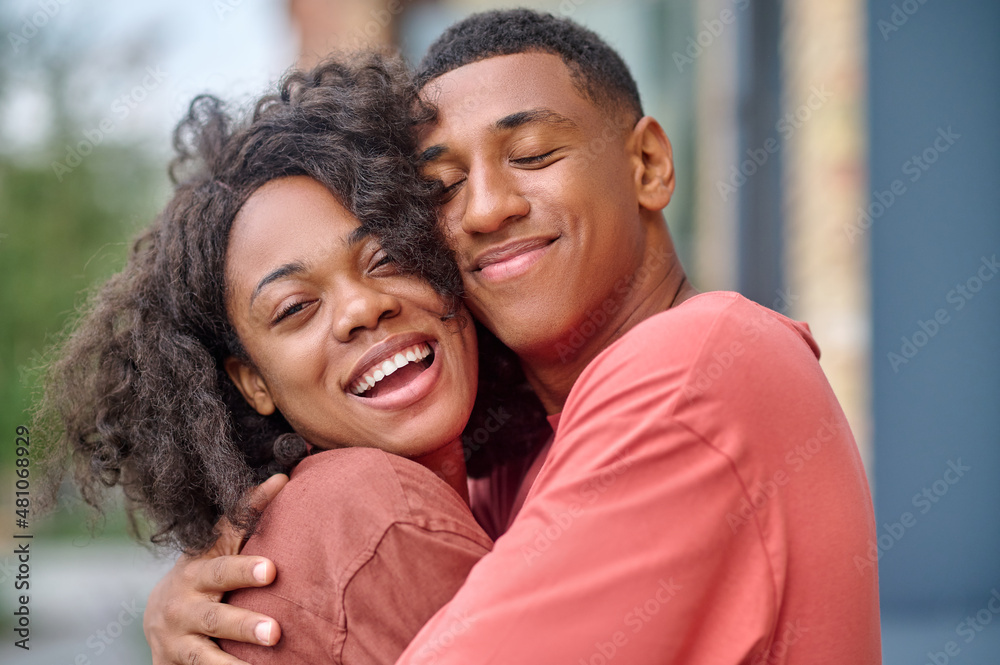 Close-up dark-skinned man and woman hugging outdoors Close-up dark-skinned man and woman hugging outdoors