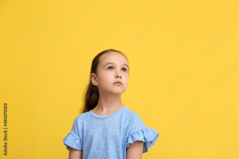 Portrait of cute little girl on yellow background Portrait of cute little girl on yellow background