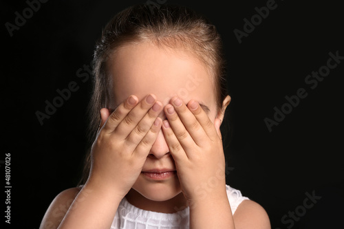 Cute little girl closing ey...