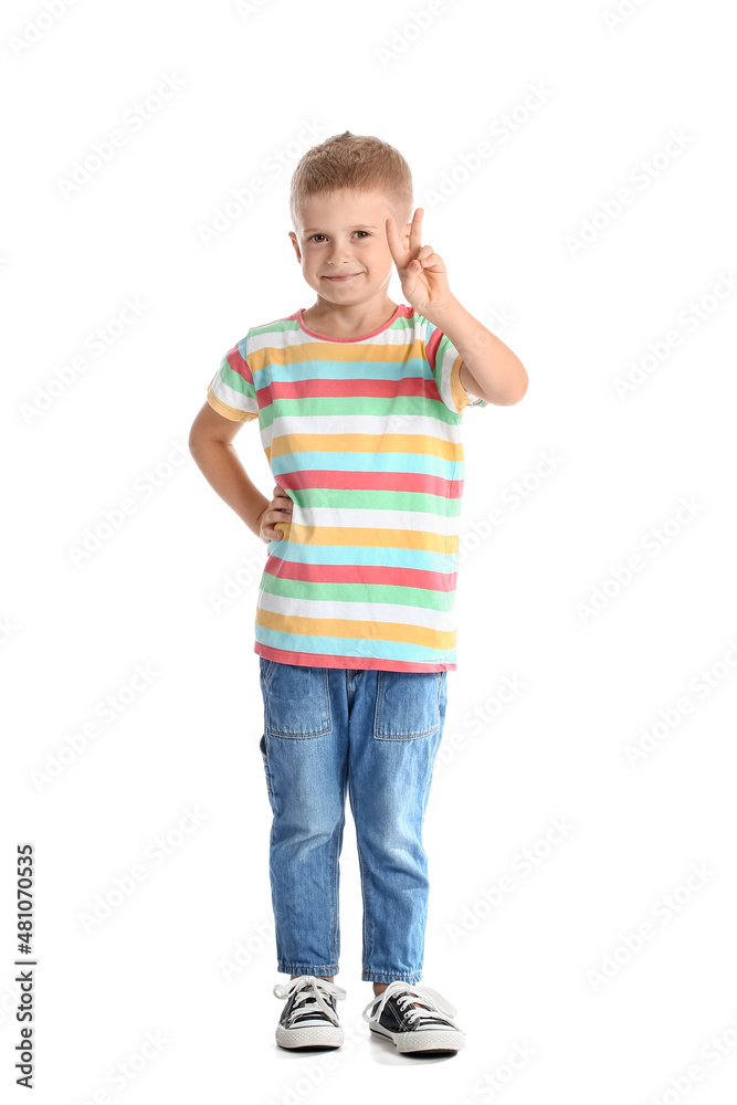 Adorable little boy in striped t-shirt showing victory gesture on white background Adorable little boy in striped t-shirt showing victory gesture on white background