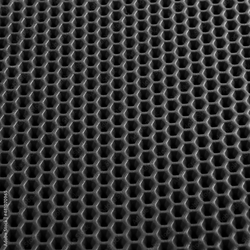 Texture of black leather background with honeycomb shape pattern, macro