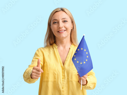 Mature woman with flag of E...