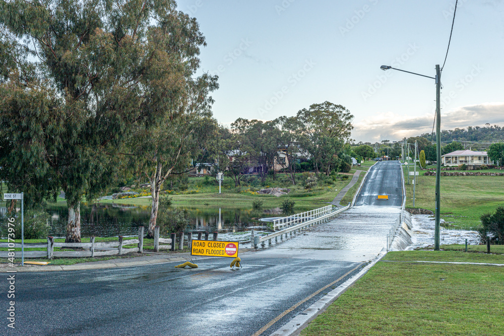Australian country road flooded with road closed sign visible