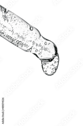Transparent pipette with cosmetics on a light background.