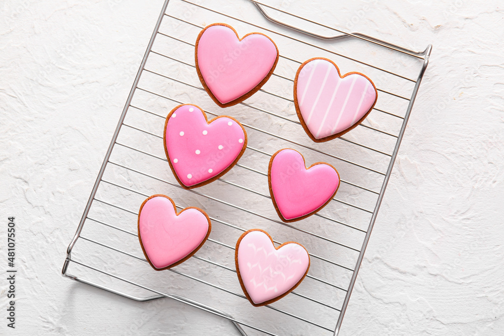 Fototapeta premium Grid with tasty heart shaped cookies on white background