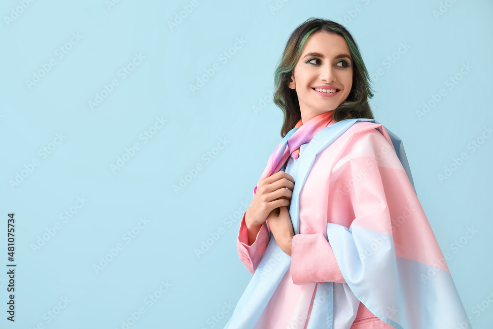 Beautiful young woman with unusual hair and transgender flag on color background - obrazy, fototapety, plakaty 