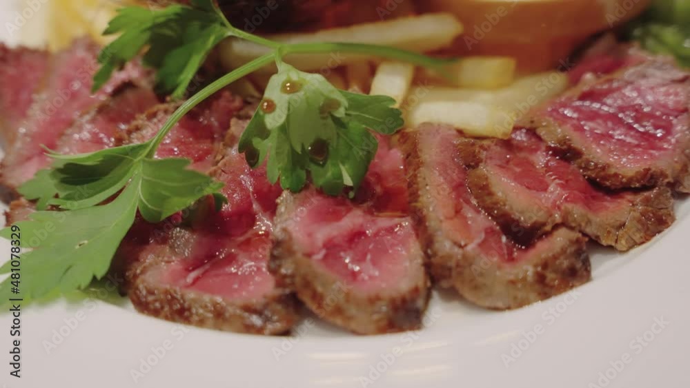 Steak on plate with fries, juicy freshly cooked meat