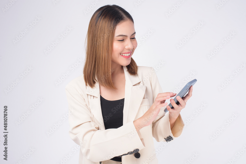 Portrait of young beautiful woman in suit using smart phone over white background. Portrait of young beautiful woman in suit using smart phone over white background.