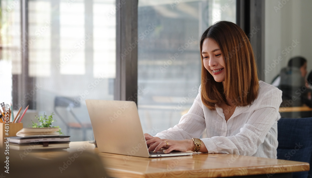 Cheerful businesswoman working with computer laptop at office. Cheerful businesswoman working with computer laptop at office.