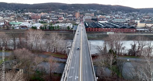 Bridge over Lehigh River in Bethlehem Pennsylvania during winter. Slow motion clip of traffic driving. Aerial. photo