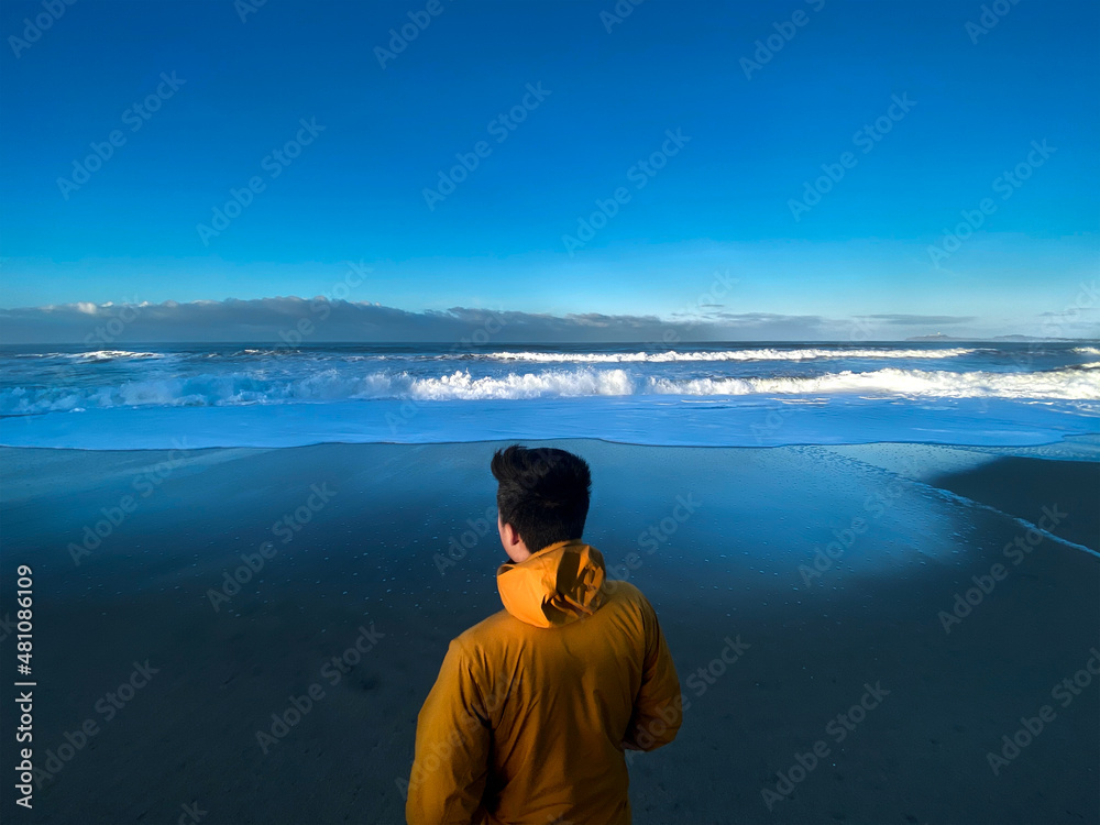 Male person looking over the ocean Male person looking over the ocean
