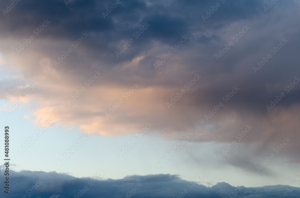 Dark volume clouds in the sky. Sunset. The last rays of the sun. Texture. Dark volume clouds in the sky. Sunset. The last rays of the sun. Texture.