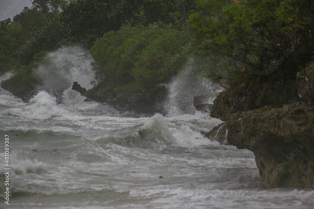 sea spray and surf on rocks in a storm with high waves on tropical cyclone sea spray and surf on rocks in a storm with high waves on tropical cyclone