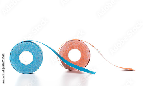 Kinesiology tape for taping in blue and orange on a white background, isolate. Close-up, isolate