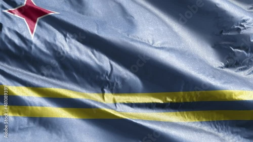 Aruba textile flag slow waving on the wind loop. Aruba banner smoothly swaying on the breeze. Fabric textile tissue. Full filling background. 20 seconds loop. photo