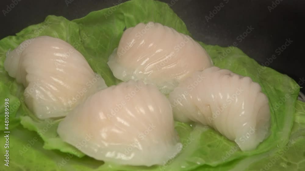 Closeup shot of dim sum shrimp dumplings in the steamer. Har Gow, Chinese crystal prawn dumpling. 4K